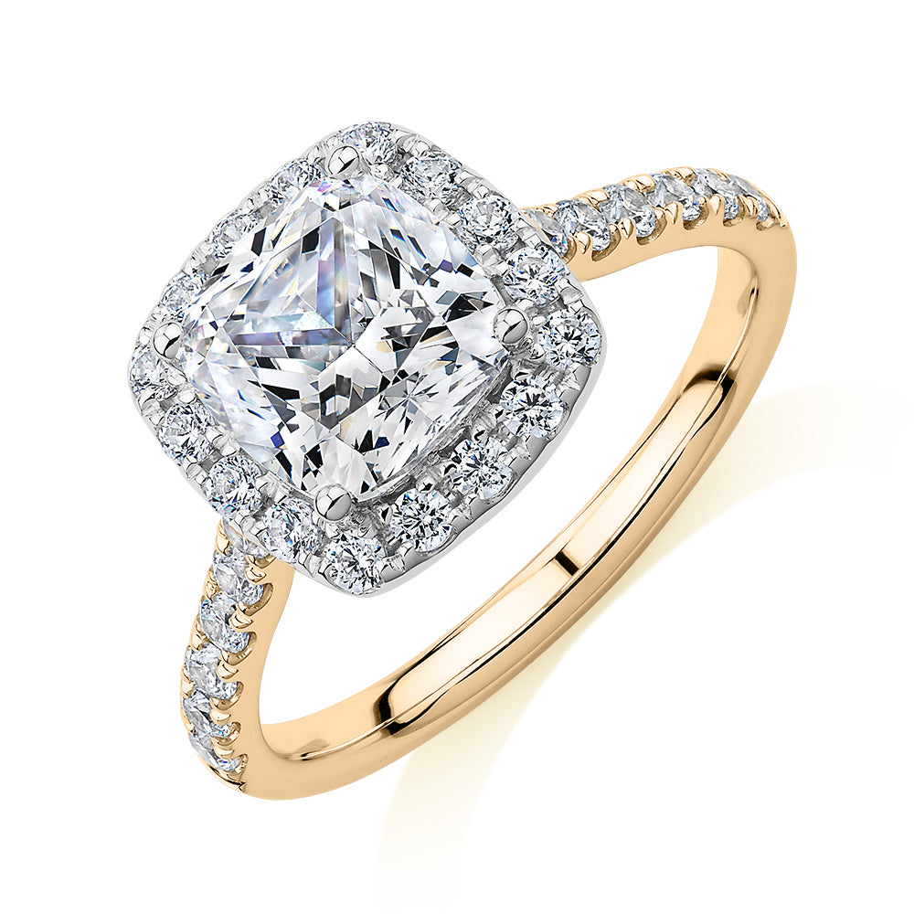 Cushion and Round Brilliant halo engagement ring with 2.09 carats* of diamond simulants in 10 carat yellow and white gold