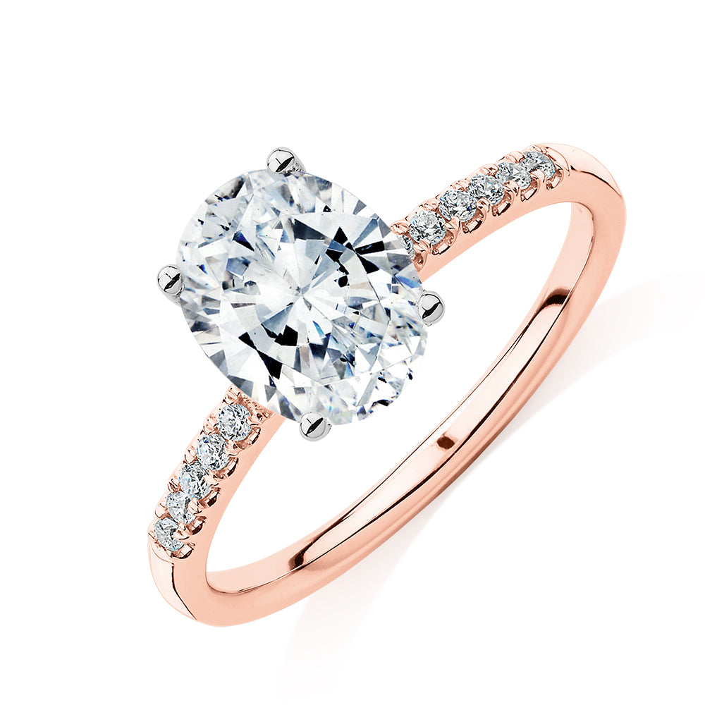 Oval and Round Brilliant shouldered engagement ring with 1.94 carats* of diamond simulants in 14 carat rose and white gold