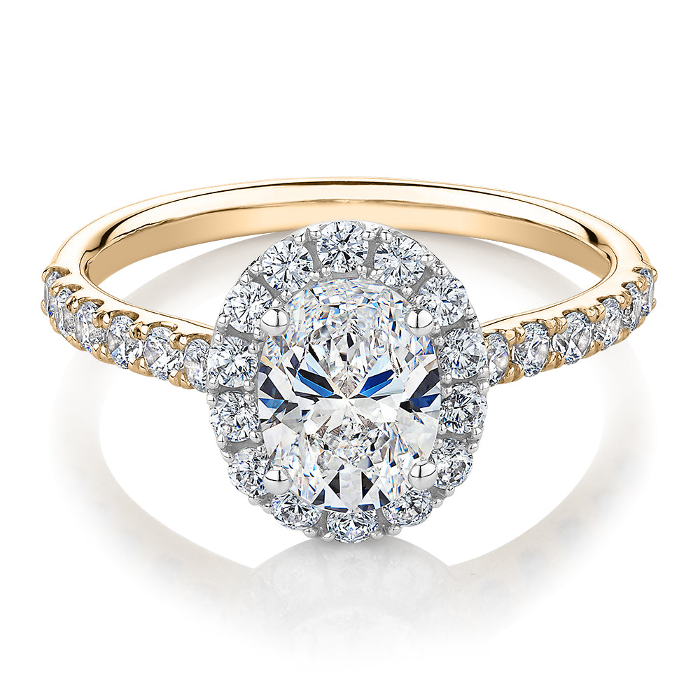 Oval and Round Brilliant halo engagement ring with 1.79 carats* of diamond simulants in 14 carat yellow and white gold