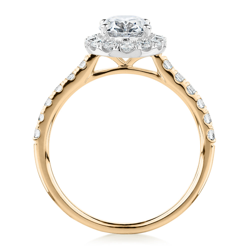 Oval and Round Brilliant halo engagement ring with 1.79 carats* of diamond simulants in 14 carat yellow and white gold