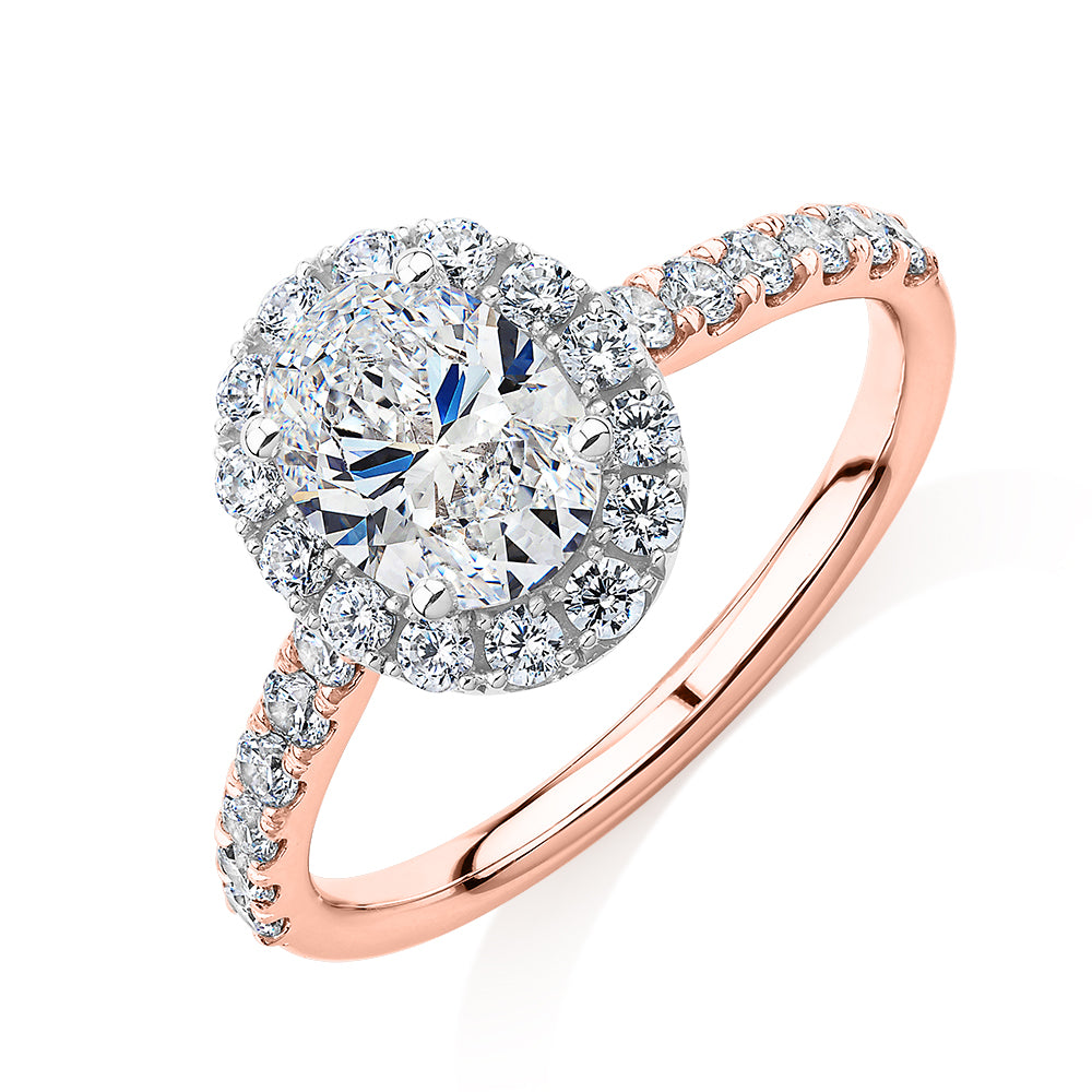 Oval and Round Brilliant halo engagement ring with 1.79 carats* of diamond simulants in 14 carat rose and white gold