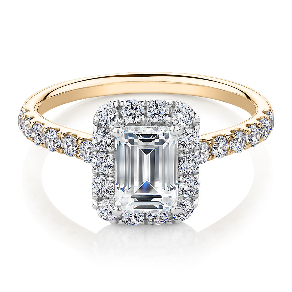 Emerald Cut and Round Brilliant halo engagement ring with 1.65 carats* of diamond simulants in 14 carat yellow and white gold