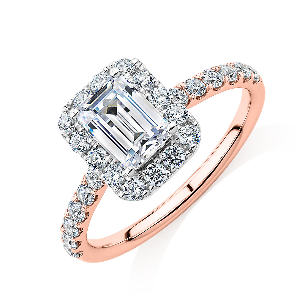 Emerald Cut and Round Brilliant halo engagement ring with 1.65 carats* of diamond simulants in 14 carat rose and white gold
