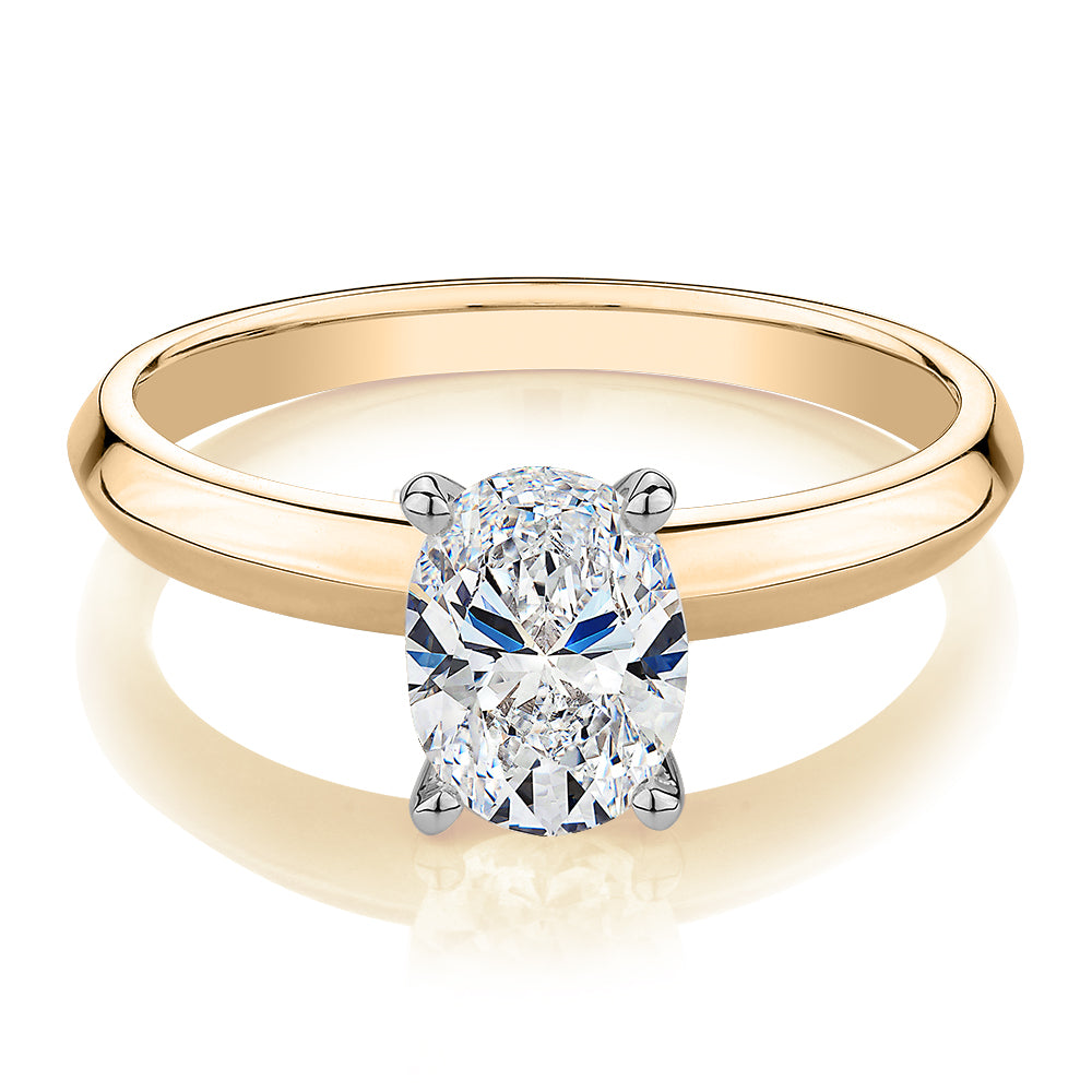 Oval solitaire engagement ring with 1.21 carat* diamond simulant in 14 carat yellow and white gold