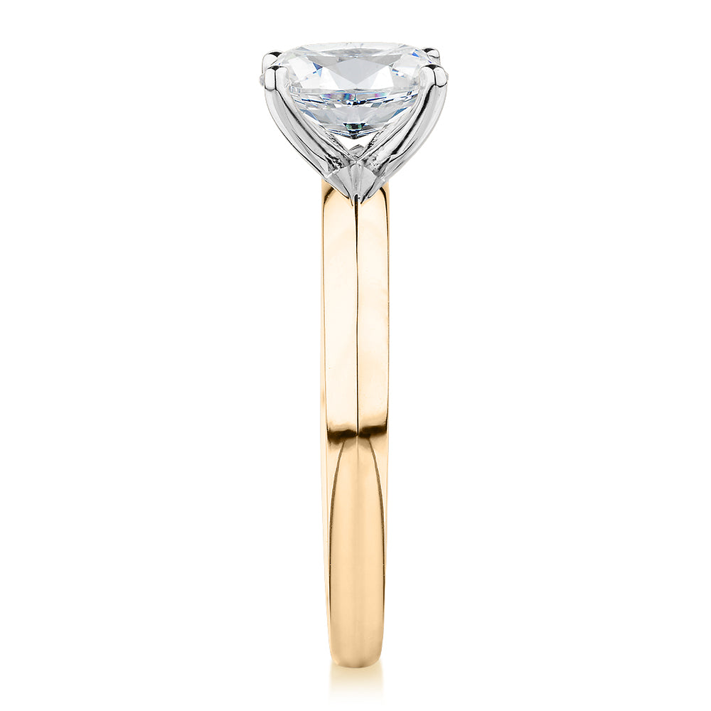 Oval solitaire engagement ring with 1.21 carat* diamond simulant in 14 carat yellow and white gold