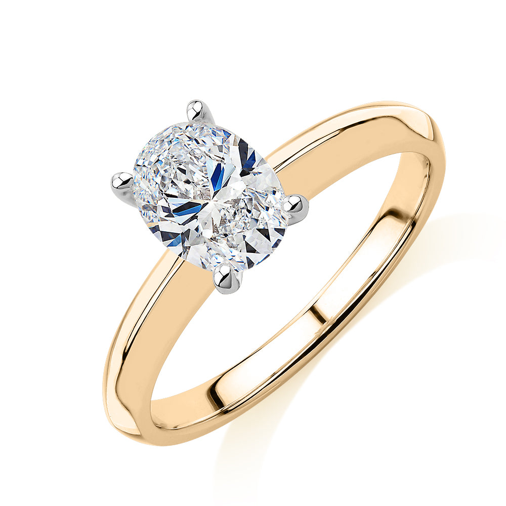 Oval solitaire engagement ring with 1.21 carat* diamond simulant in 14 carat yellow and white gold
