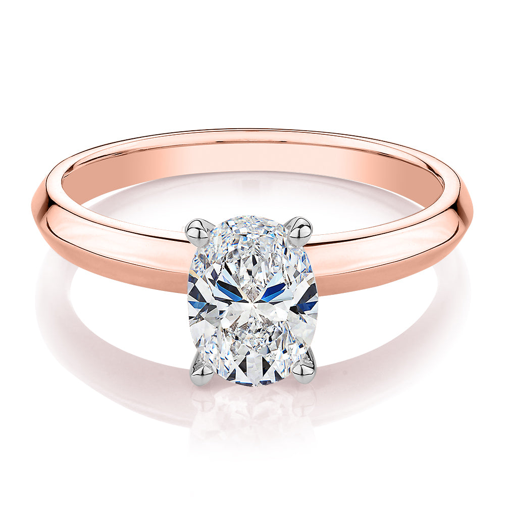 Oval solitaire engagement ring with 1.21 carat* diamond simulant in 14 carat rose and white gold