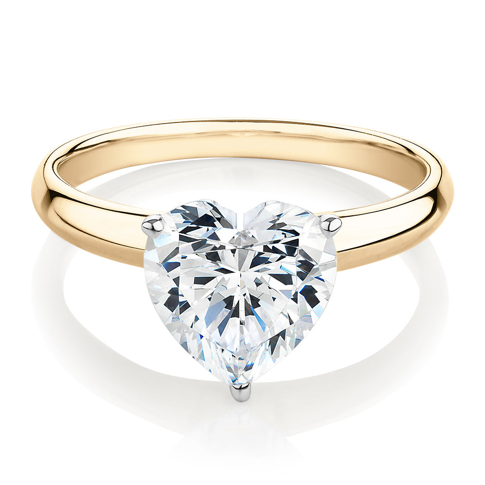 Heart solitaire engagement ring with carat* diamond simulant in 14 carat yellow and white gold