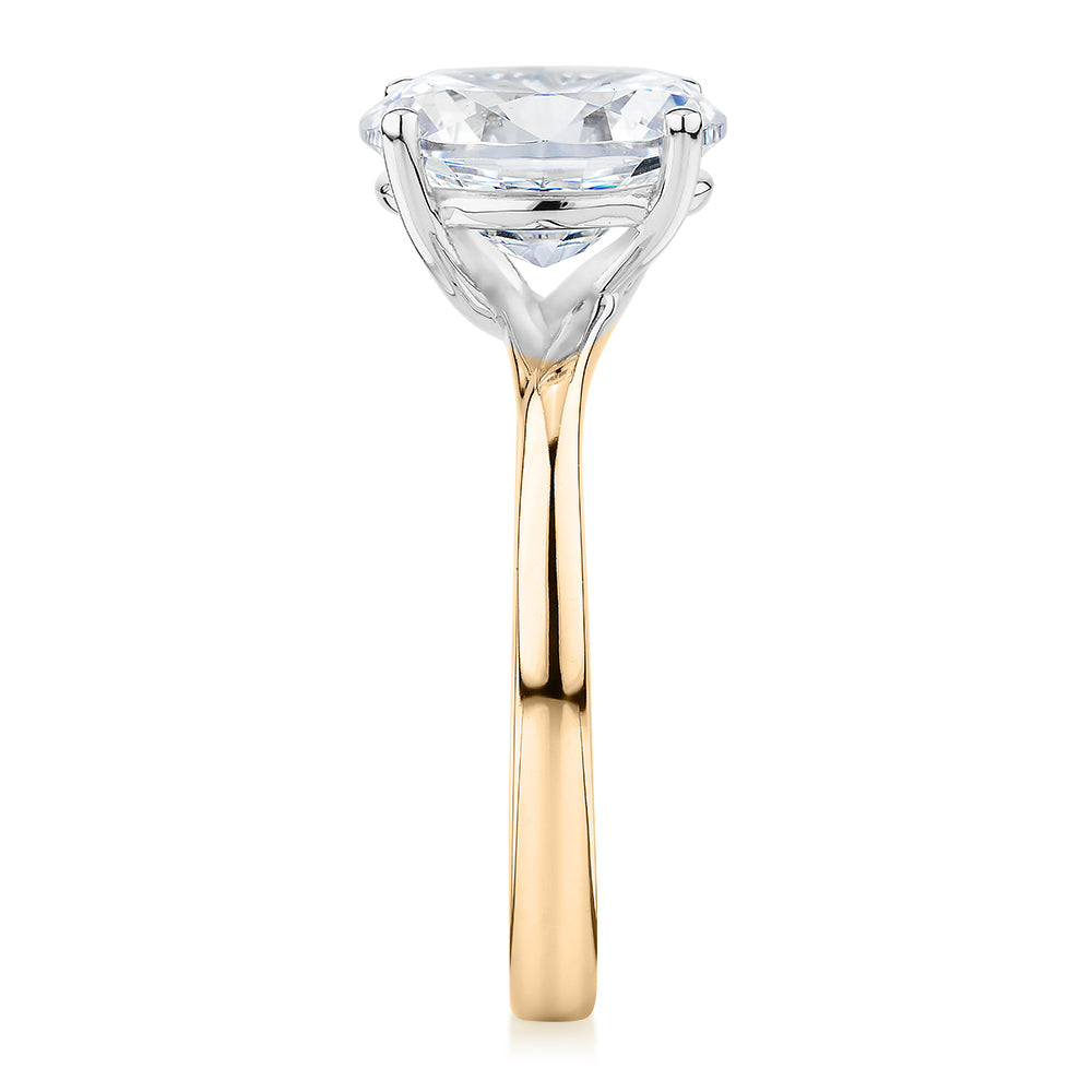 Oval solitaire engagement ring with 2.54 carat* diamond simulant in 14 carat yellow and white gold