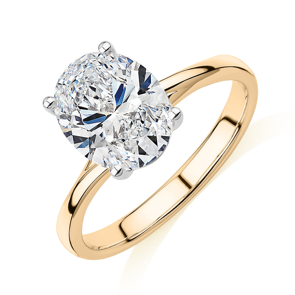 Oval solitaire engagement ring with 2.54 carat* diamond simulant in 14 carat yellow and white gold