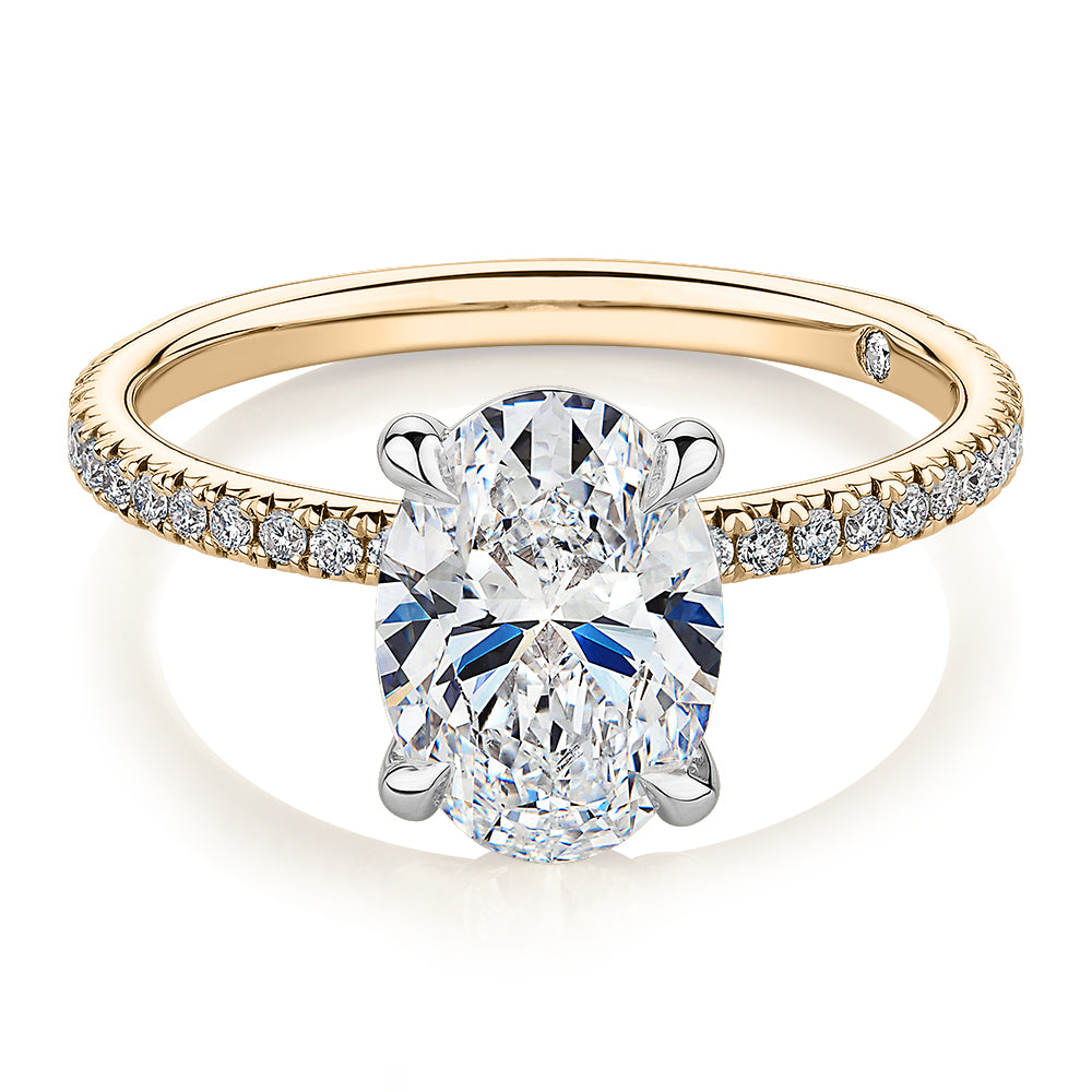 Signature Simulant Diamond 2.19 carat* TW oval cut shouldered engagement ring in 14 carat yellow and white gold