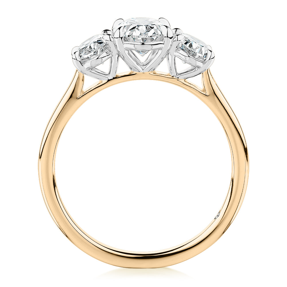 Signature Simulant Diamond 1.87 carat* TW oval three stone ring in 14 carat yellow and white gold
