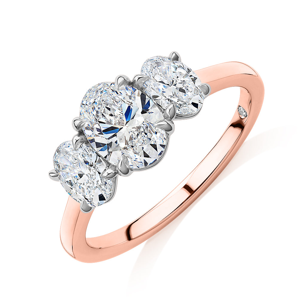 Signature Simulant Diamond 1.87 carat* TW oval three stone ring in 14 carat rose and white gold