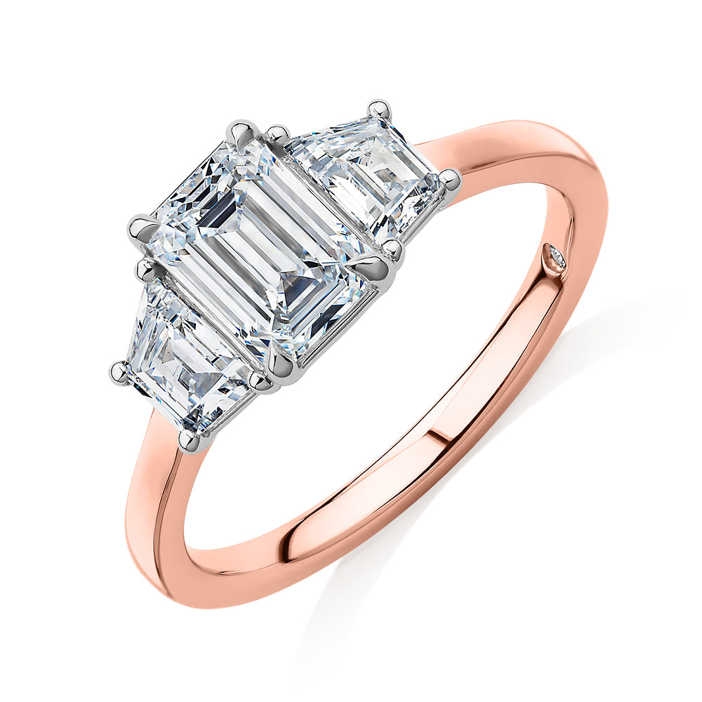 Signature Simulant Diamond 1.87 carat* TW emerald cut three stone ring in 14 carat rose and white gold