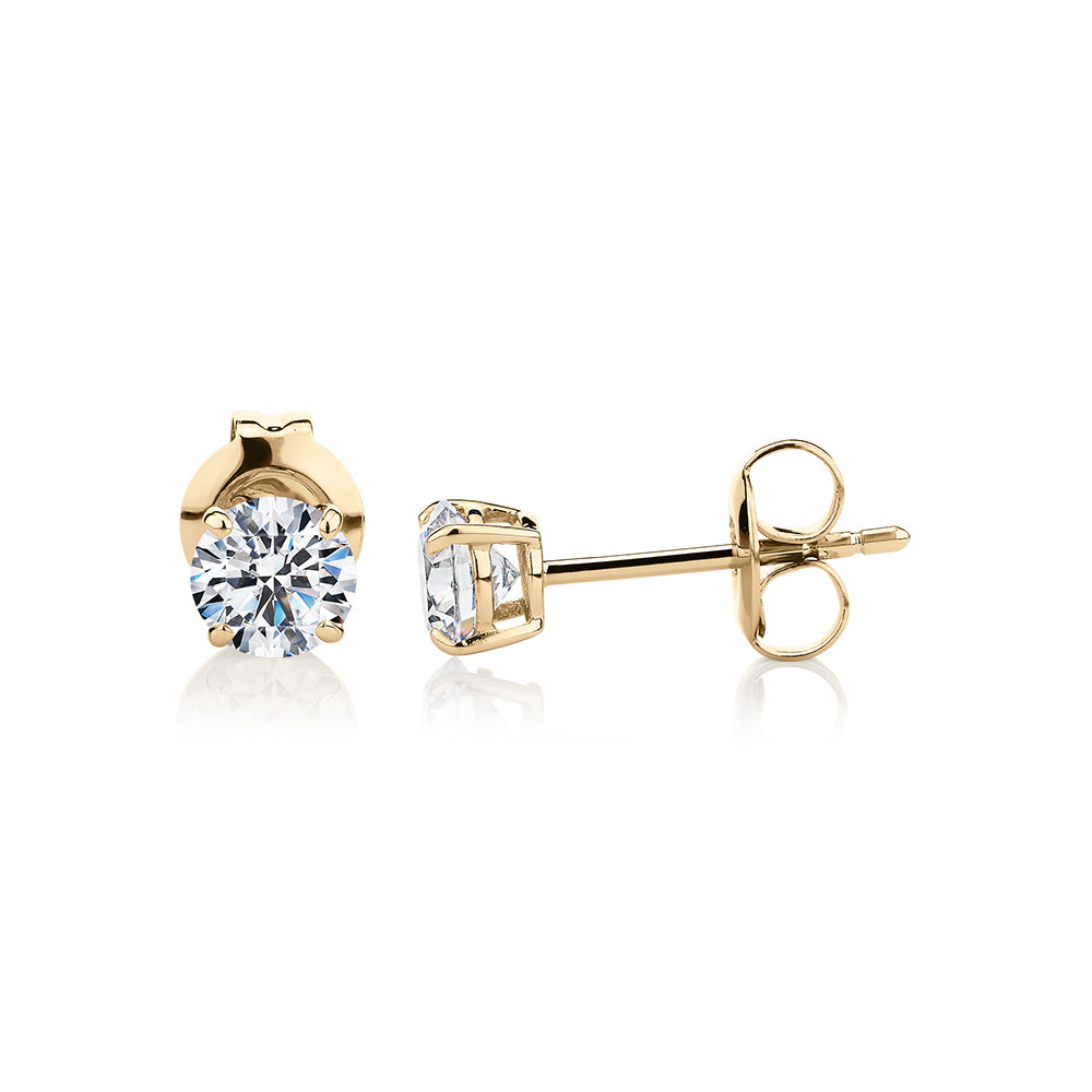 Round Brilliant stud earrings with 0.75 carats* of diamond simulants in 10 carat yellow gold