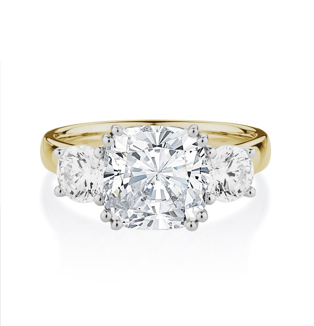 Three stone ring with 3.75 carats* of diamond simulants in 10 carat yellow and white gold