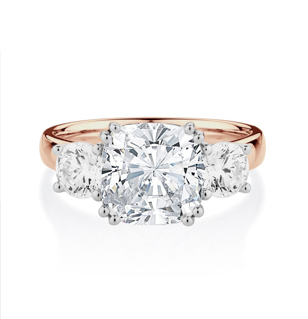 Three stone ring with 3.75 carats* of diamond simulants in 10 carat rose and white gold