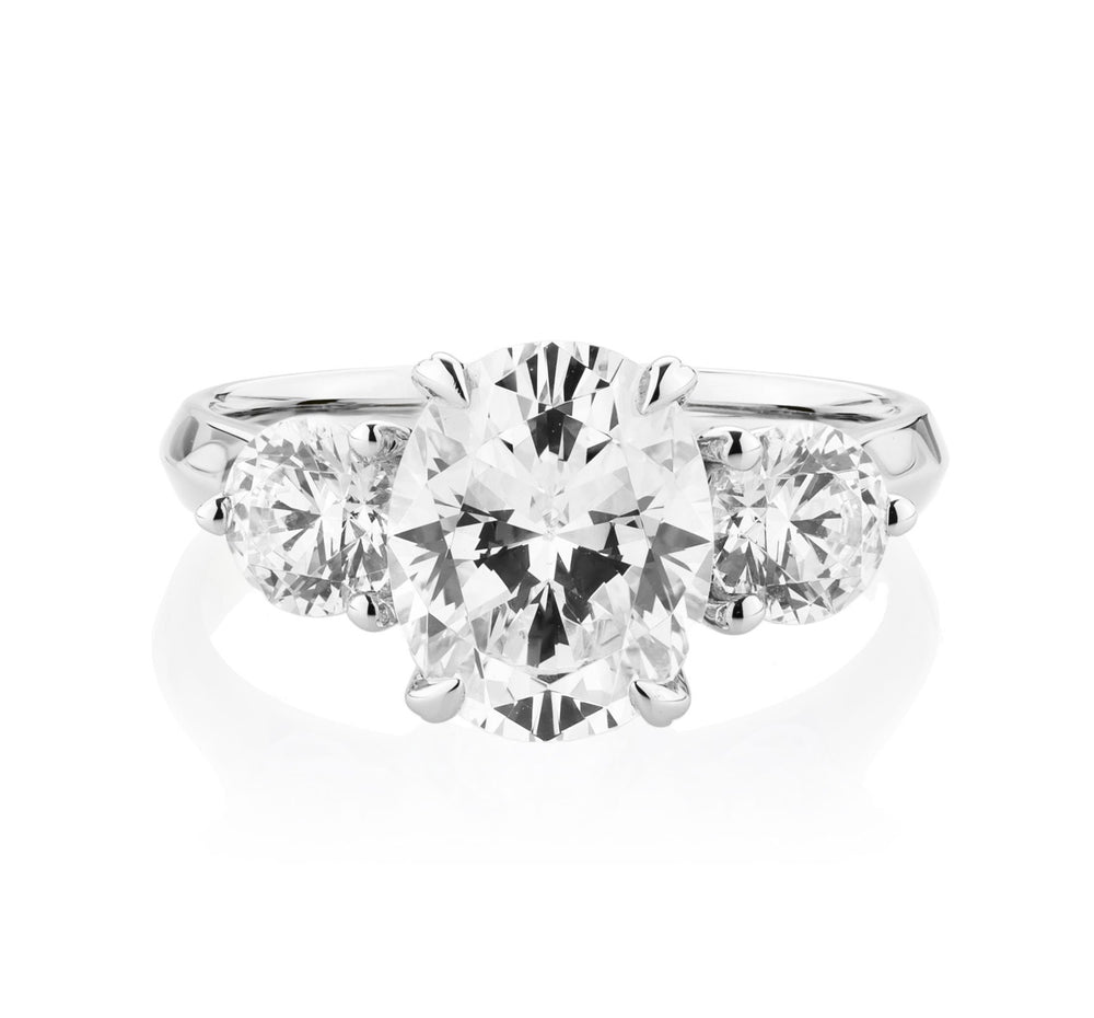 Three stone ring with 3.46 carats* of diamond simulants in 10 carat white gold