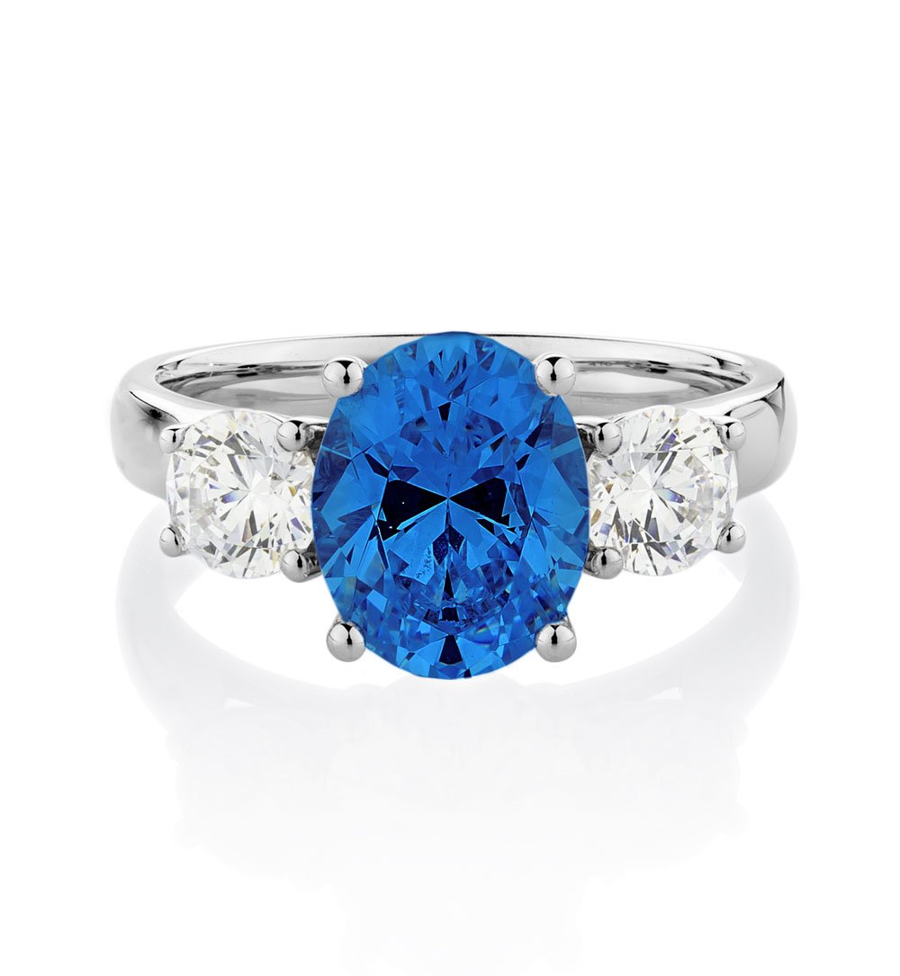 Three stone ring with 10x8mm ceylon sapphire simulant and 0.92 carats* of diamond simulants in 10 carat white gold