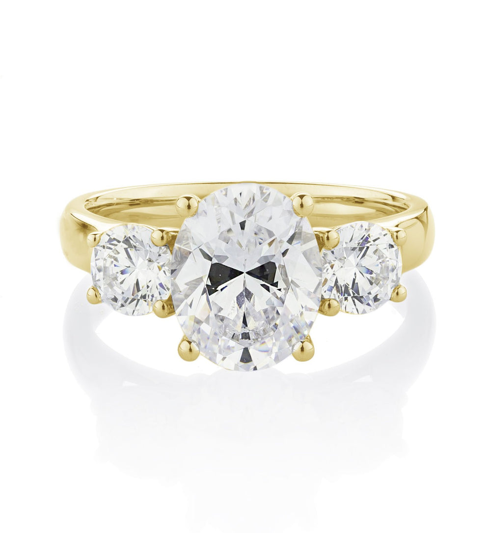 Three stone ring with 3.5 carats* of diamond simulants in 10 carat yellow gold