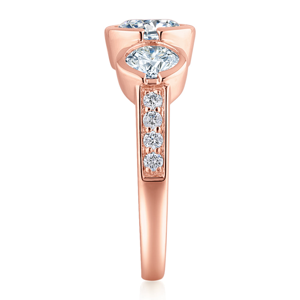 Three stone ring with 2.11 carats* of diamond simulants in 10 carat rose gold