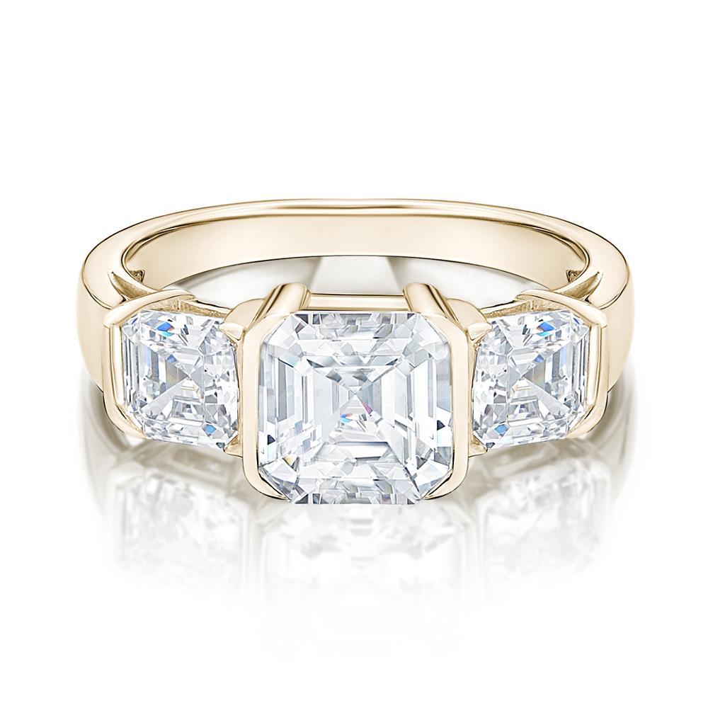 Three stone ring with 3.38 carats* of diamond simulants in 10 carat yellow gold
