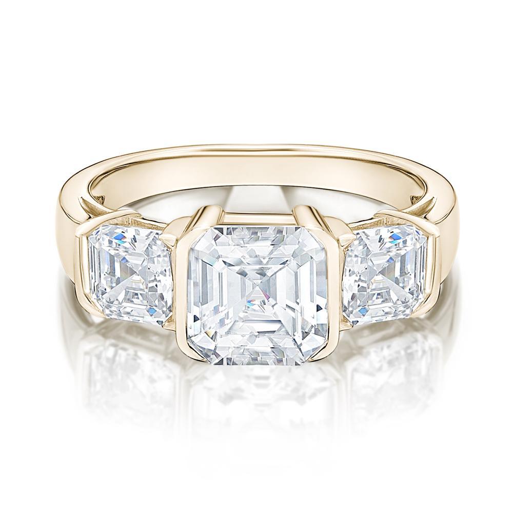 Three stone ring with 3.38 carats* of diamond simulants in 10 carat yellow gold
