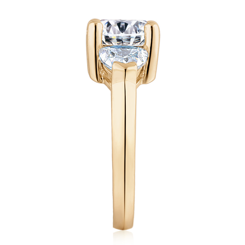 Three stone ring with 4.15 carats* of diamond simulants in 10 carat yellow gold