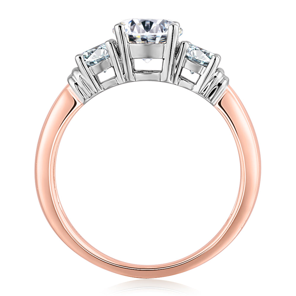Three stone ring with 1.53 carats* of diamond simulants in 14 carat rose and white gold