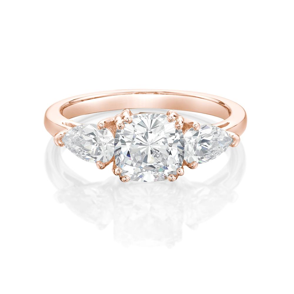 Three stone ring with 2.5 carats* of diamond simulants in 10 carat rose gold