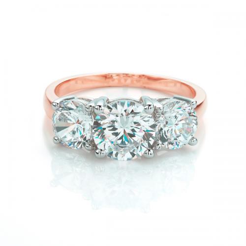 Three stone ring with 3 carats* of diamond simulants in 10 carat rose and white gold