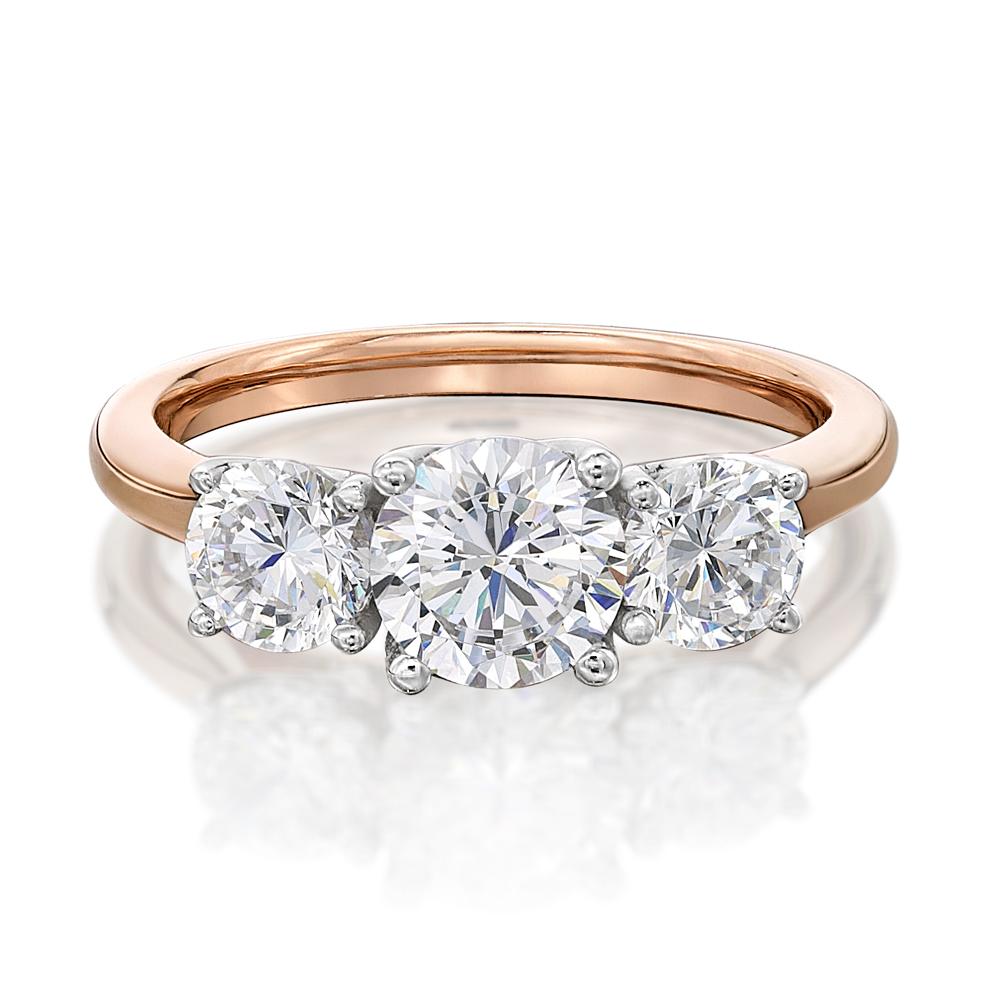 Three stone ring with 2 carats* of diamond simulants in 10 carat rose and white gold