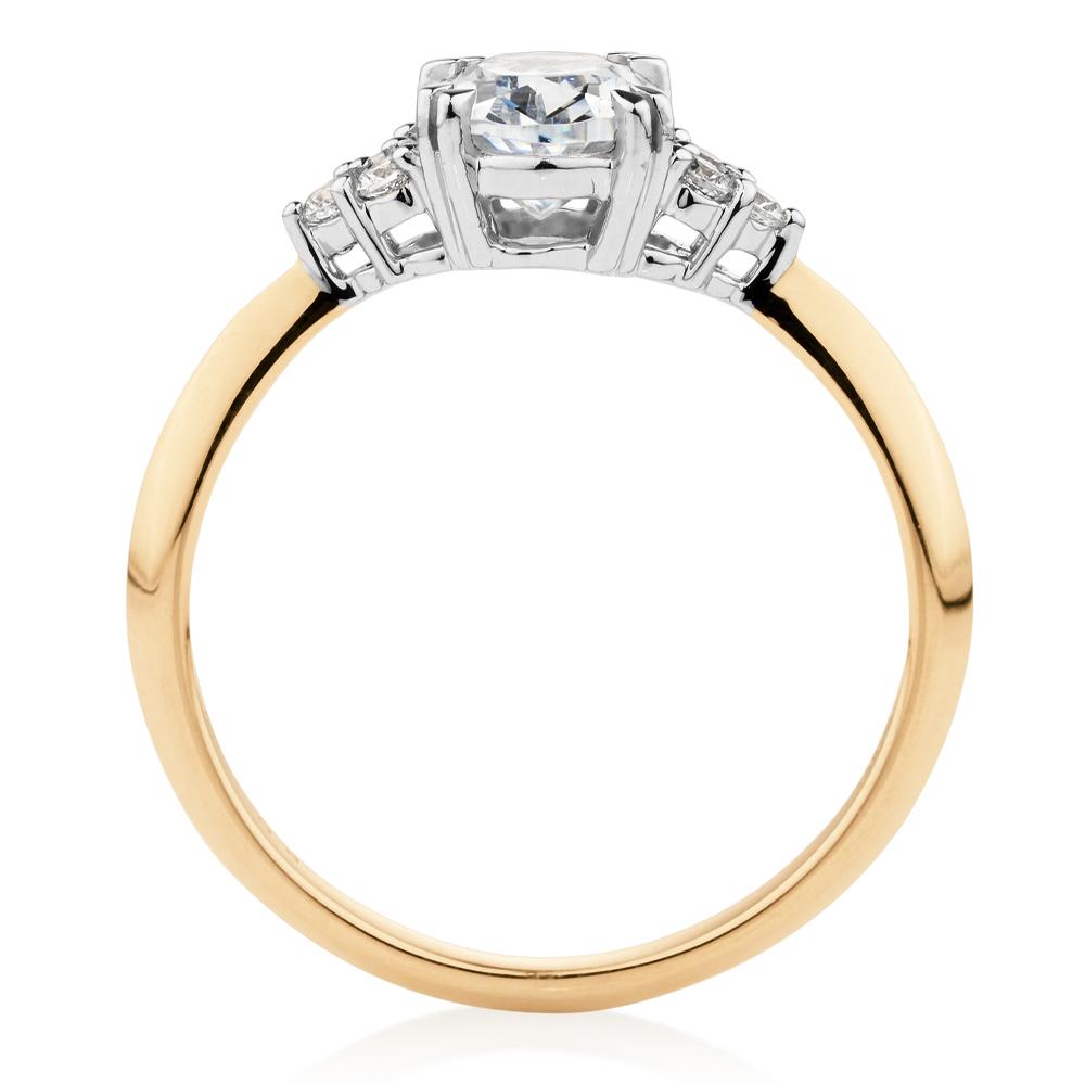 Oval and Round Brilliant shouldered engagement ring with 1.3 carats* of diamond simulants in 14 carat yellow and white gold