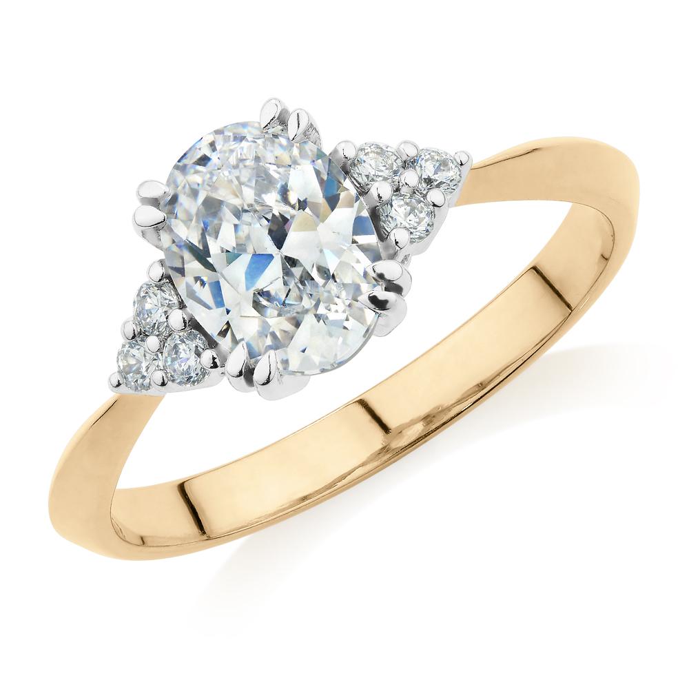 Oval and Round Brilliant shouldered engagement ring with 1.3 carats* of diamond simulants in 14 carat yellow and white gold