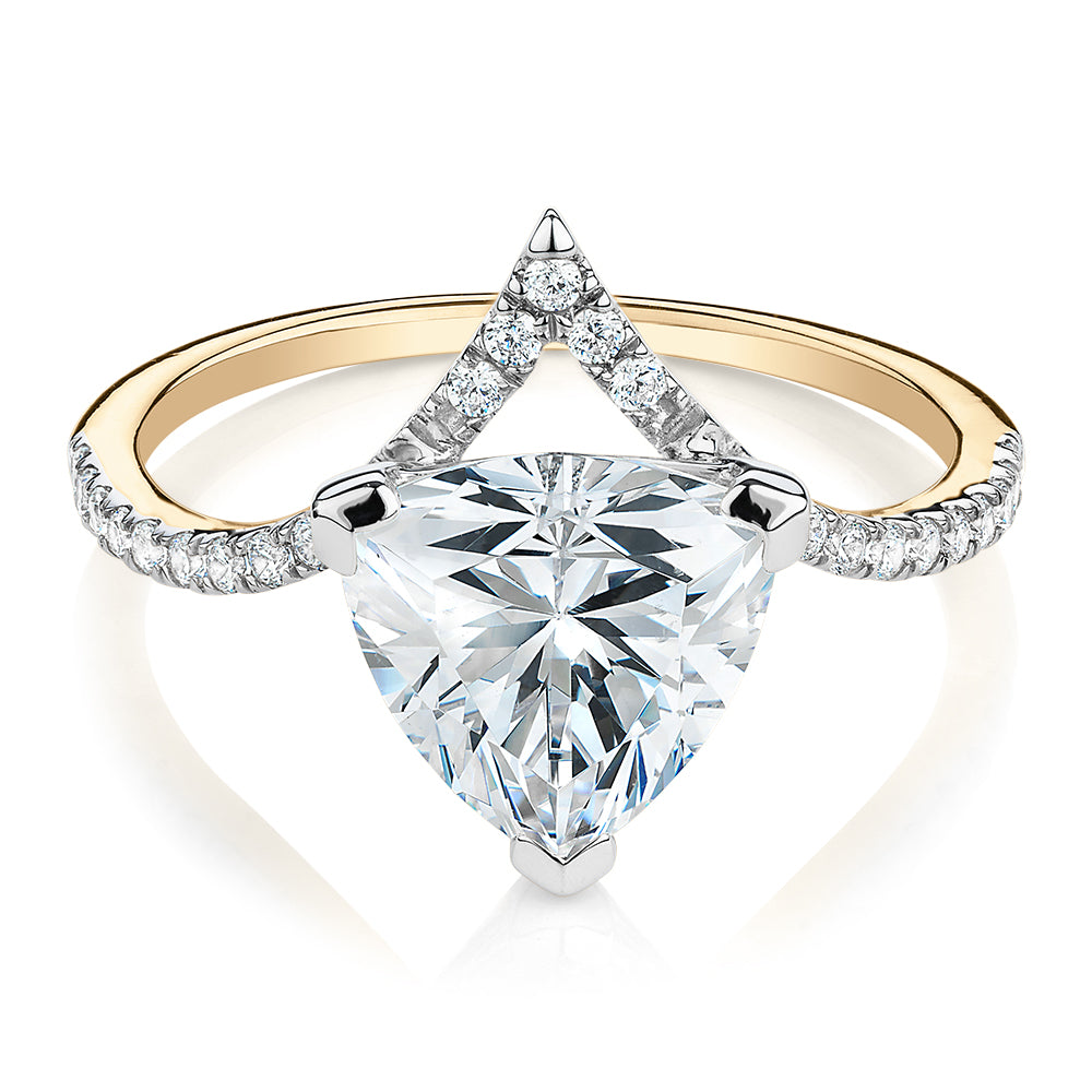 Trilliant and Round Brilliant shouldered engagement ring with carats* of diamond simulants in 14 carat yellow and white gold