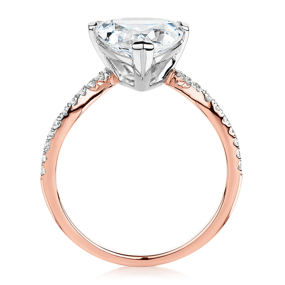 Trilliant and Round Brilliant shouldered engagement ring with 2.52 carats* of diamond simulants in 14 carat rose and white gold