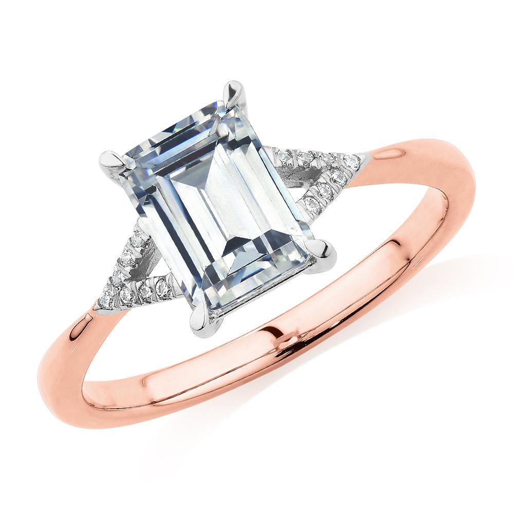 Emerald Cut and Round Brilliant shouldered engagement ring with 1.78 carats* of diamond simulants in 14 carat rose and white gold