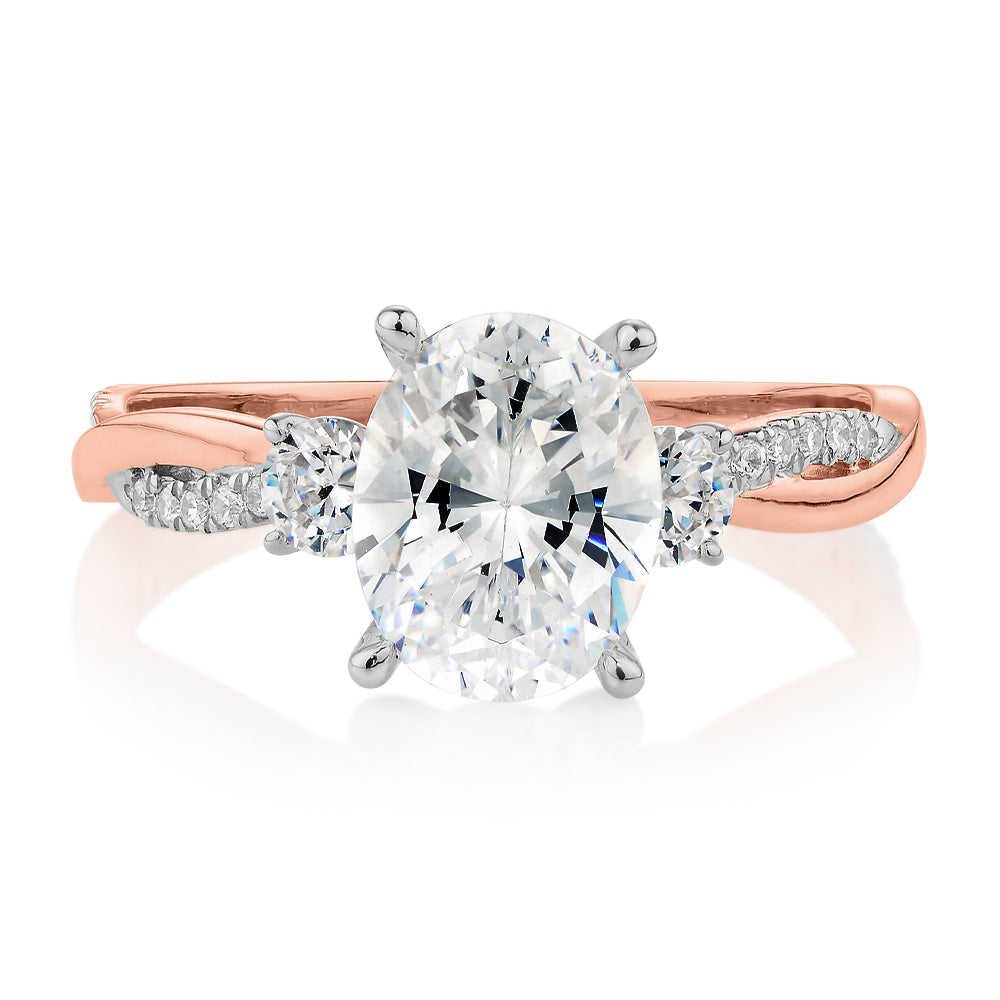 Oval and Round Brilliant shouldered engagement ring with 2.17 carats* of diamond simulants in 14 carat rose and white gold
