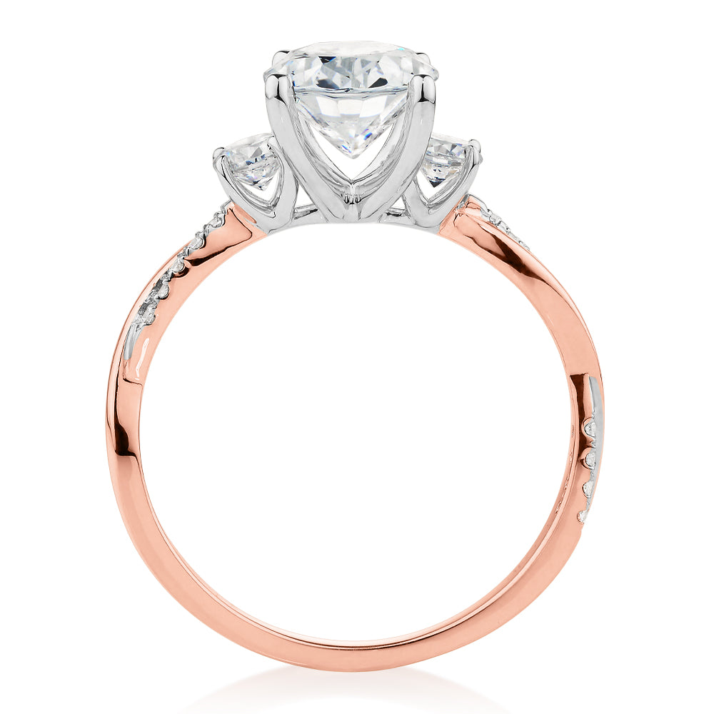 Oval and Round Brilliant shouldered engagement ring with 2.17 carats* of diamond simulants in 14 carat rose and white gold