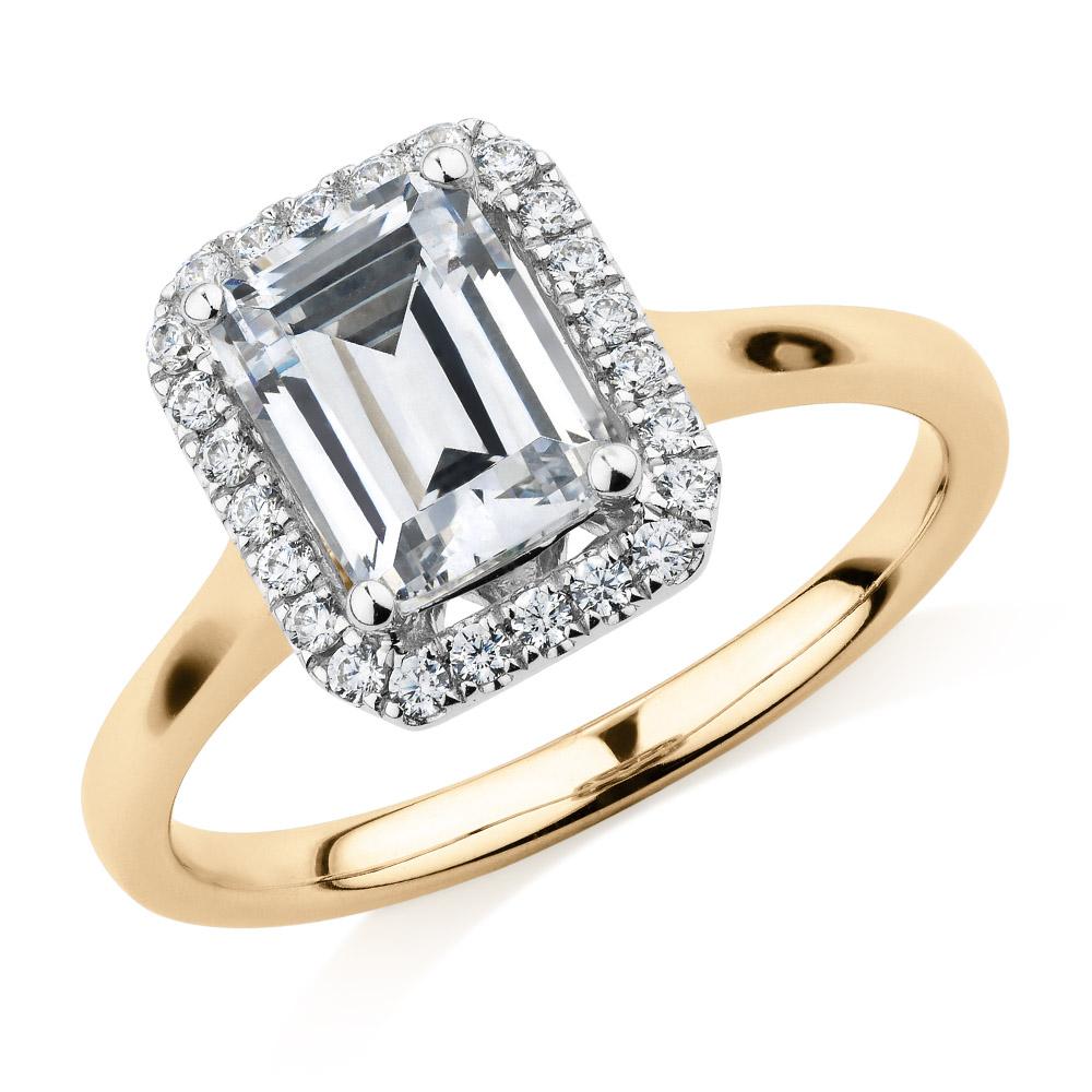 Emerald Cut and Round Brilliant halo engagement ring with 1.92 carats* of diamond simulants in 14 carat yellow and white gold