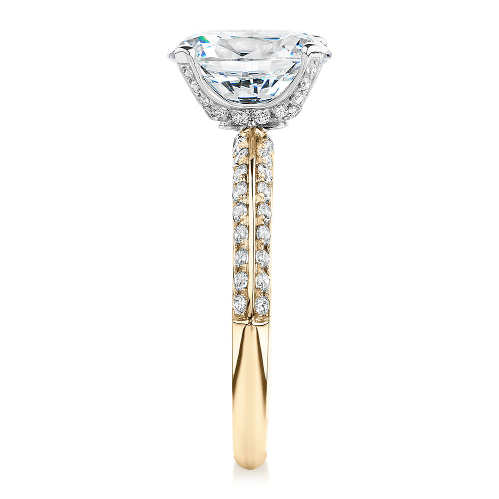 Oval shouldered engagement ring with 2.97 carats* of diamond simulants in 14 carat yellow and white gold