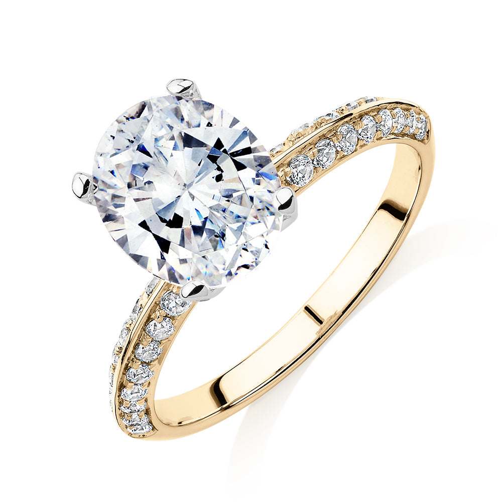 Oval shouldered engagement ring with 2.97 carats* of diamond simulants in 14 carat yellow and white gold