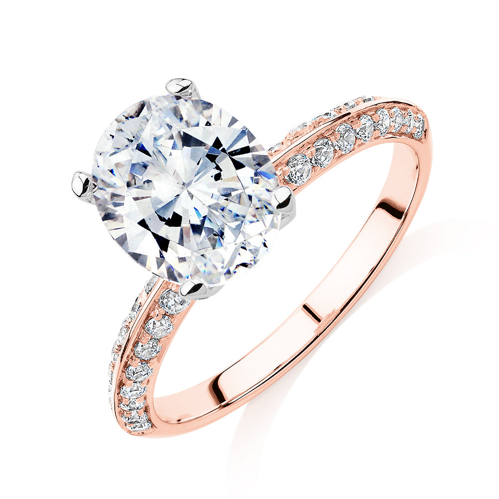 Oval shouldered engagement ring with 2.97 carats* of diamond simulants in 14 carat rose and white gold