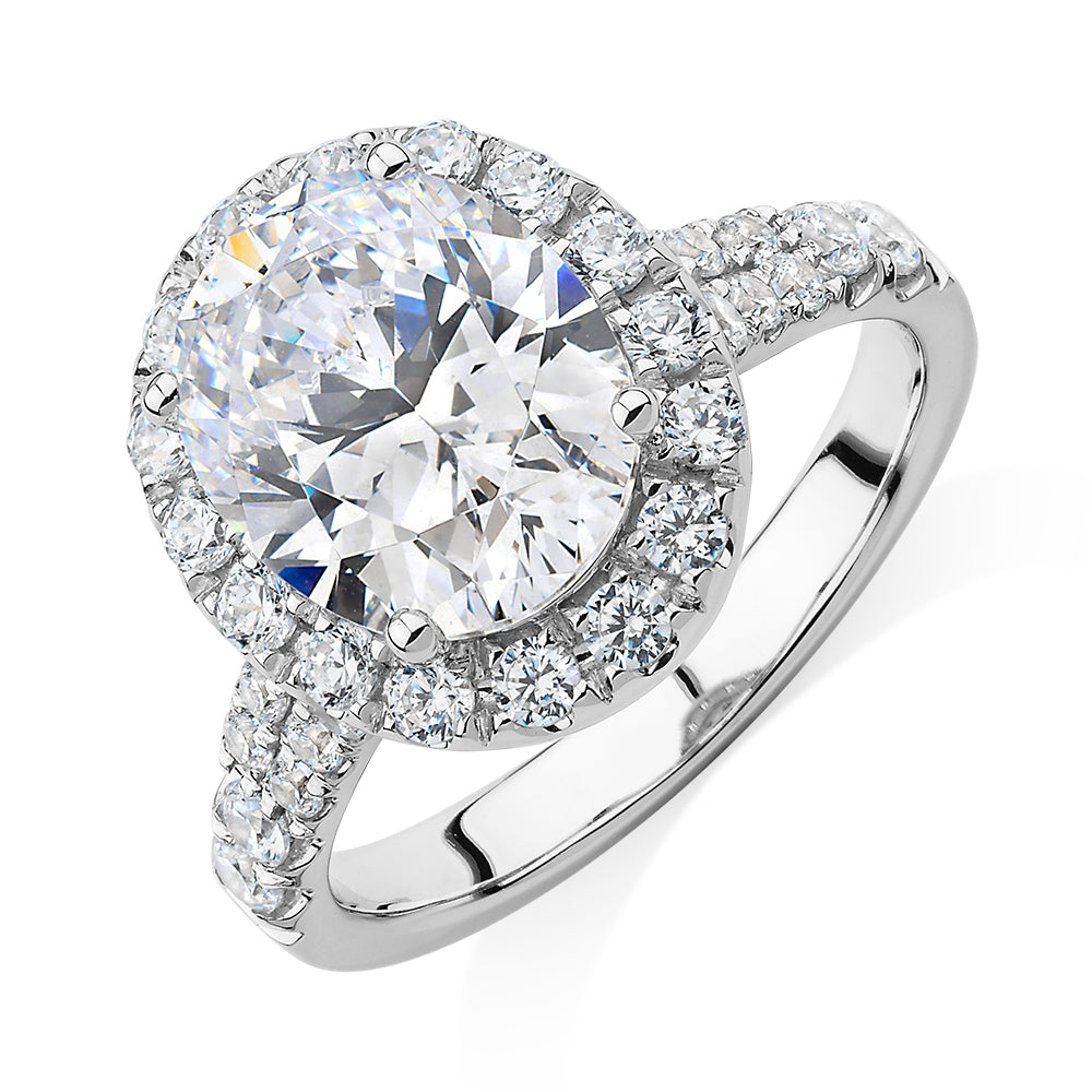 Oval and Round Brilliant halo engagement ring with 4.61 carats* of diamond simulants in 10 carat white gold
