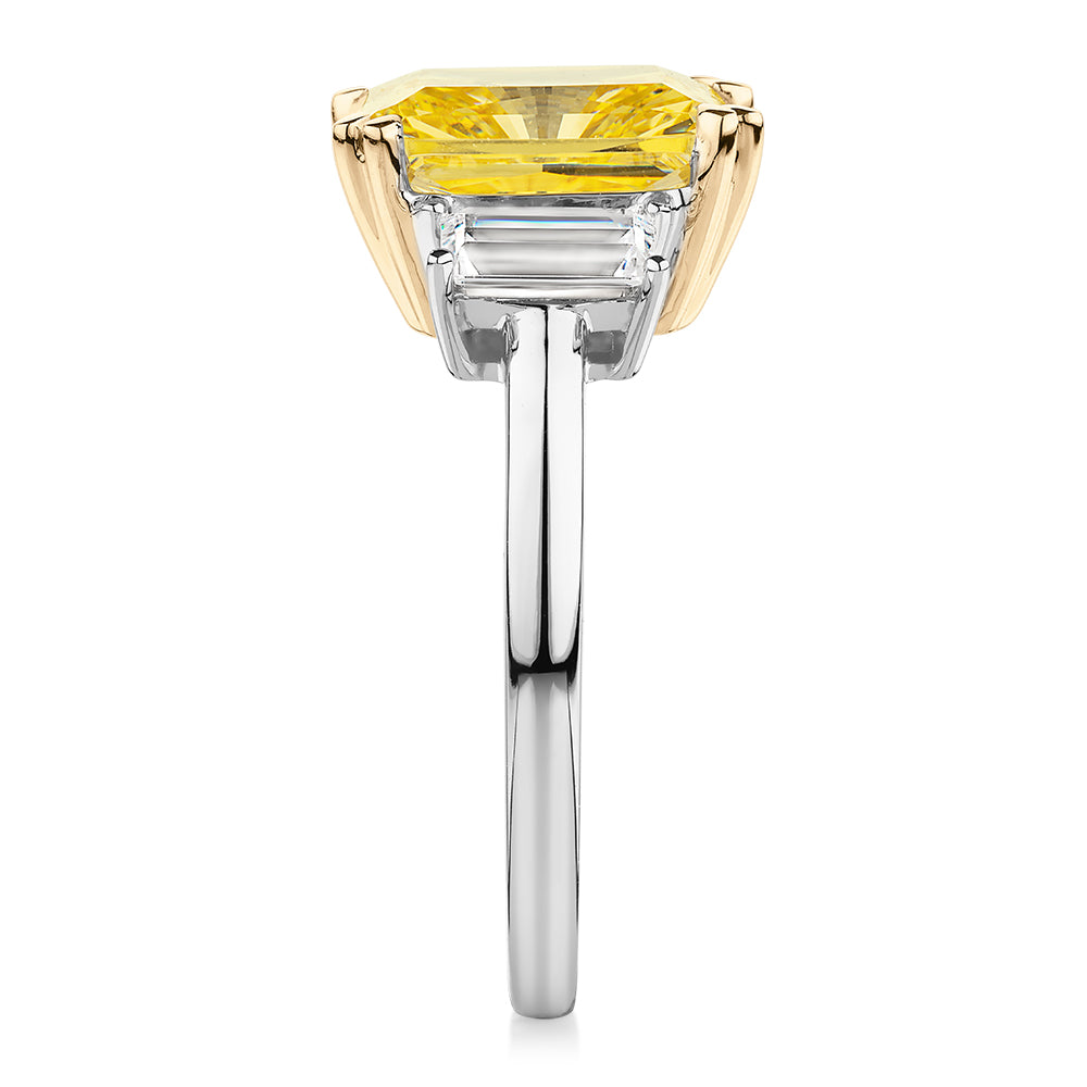 Emerald Cut and Baguette shouldered engagement ring with 4.25 carats* of diamond simulants in 10 carat white and yellow gold