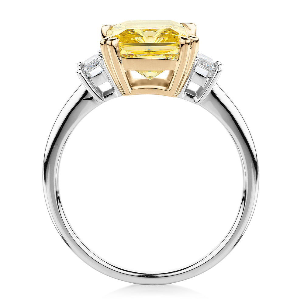 Emerald Cut and Baguette shouldered engagement ring with 4.25 carats* of diamond simulants in 10 carat white and yellow gold
