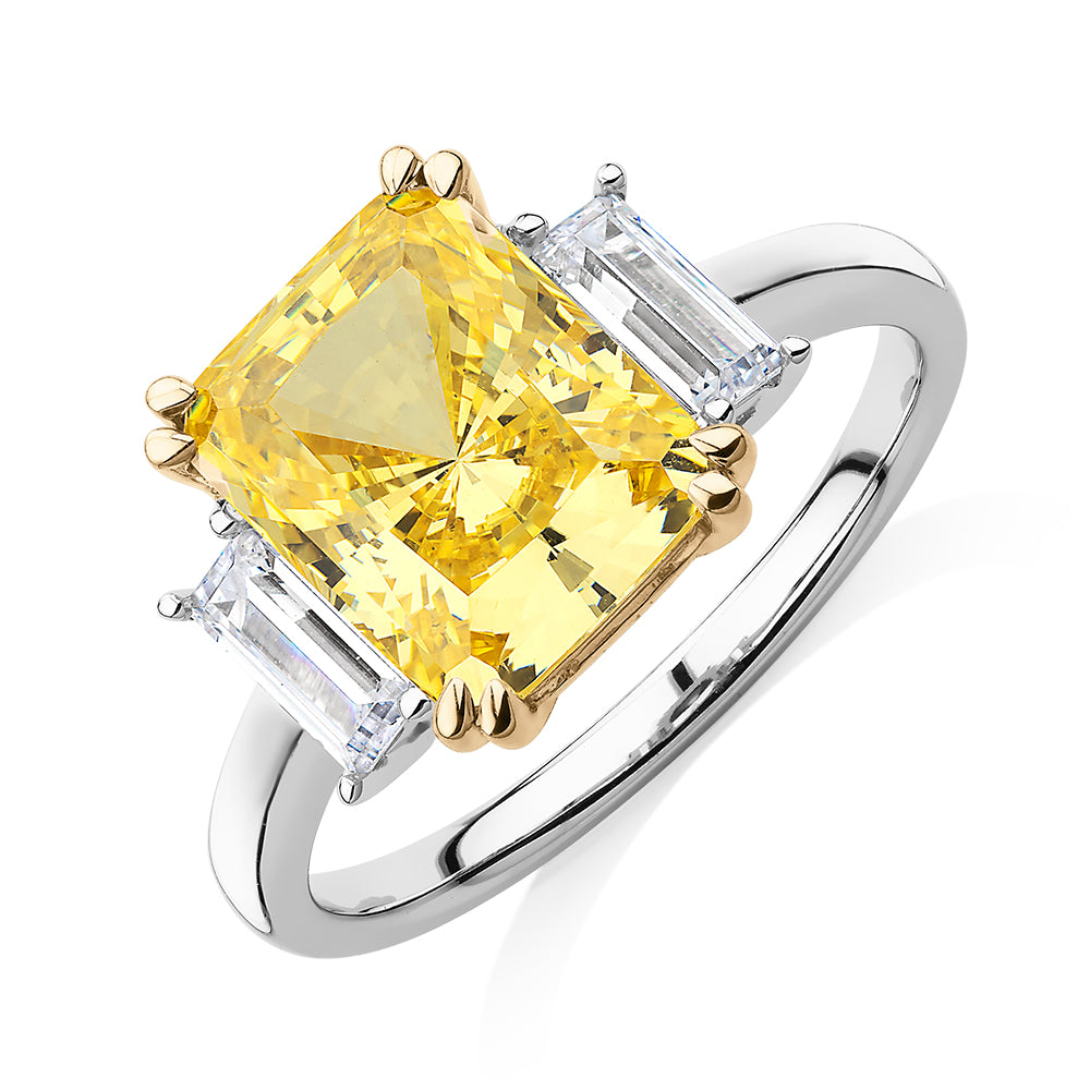 Emerald Cut and Baguette shouldered engagement ring with 4.25 carats* of diamond simulants in 10 carat white and yellow gold