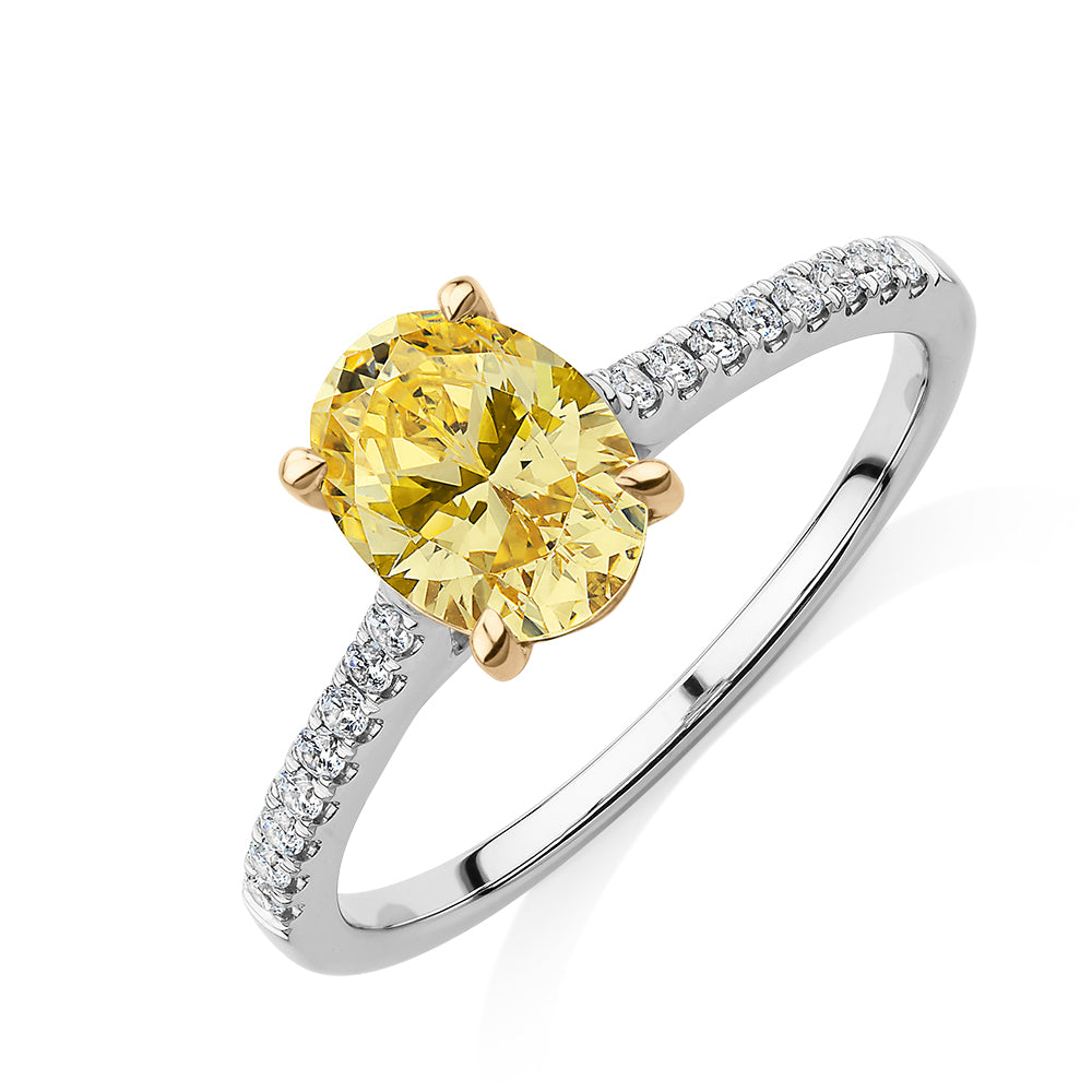 Oval and Round Brilliant shouldered engagement ring with 1.35 carats* of diamond simulants in 10 carat white and yellow gold