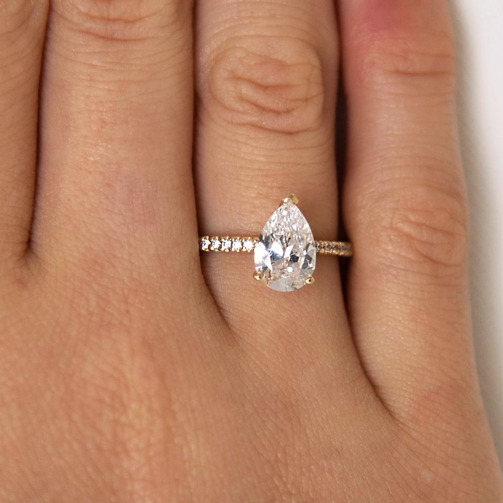 Pear and Round Brilliant shouldered engagement ring with 1.88 carats* of diamond simulants in 14 carat yellow gold