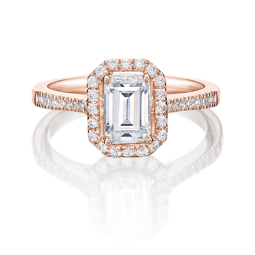 Emerald Cut and Round Brilliant halo engagement ring with 1.29 carats* of diamond simulants in 14 carat rose gold